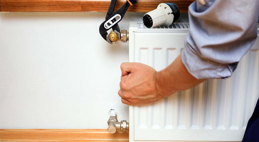 Bedford Plumber fitting a Radiator 